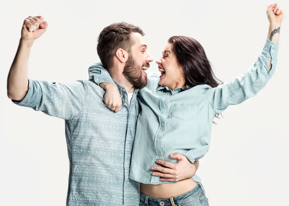 Happy couple celebrating in luxury Verbier chalet, embodying comfort and joy with GuestLee Swiss property rentals. | GuestLee luxury rental Switzerland