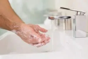 How to Apply a Topical Finasteride and Minoxidil Combination Spray man washing hands after applying topical combo hair loss spray