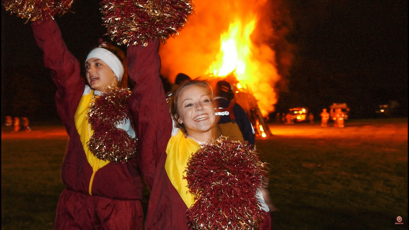 cheerleaders in front of bonfire
