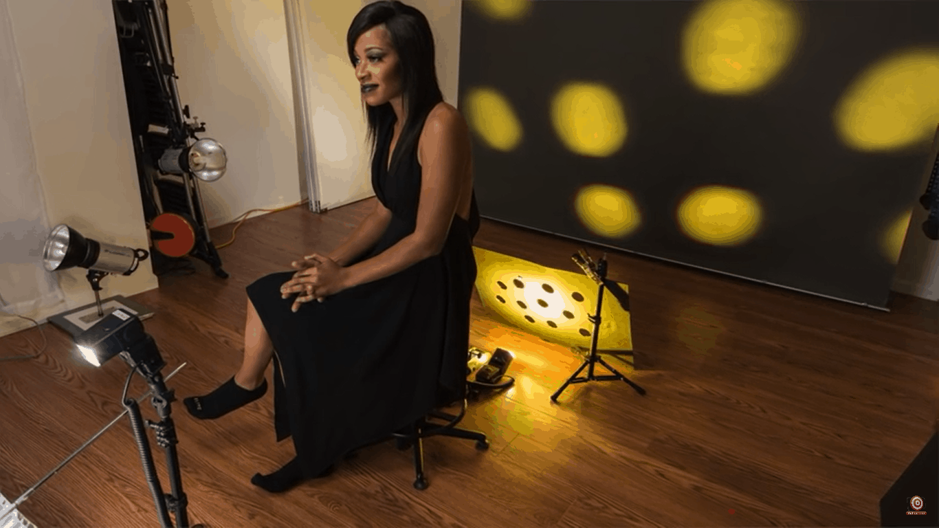 Light behind model with yellow gel shooting through gobo to backdrop