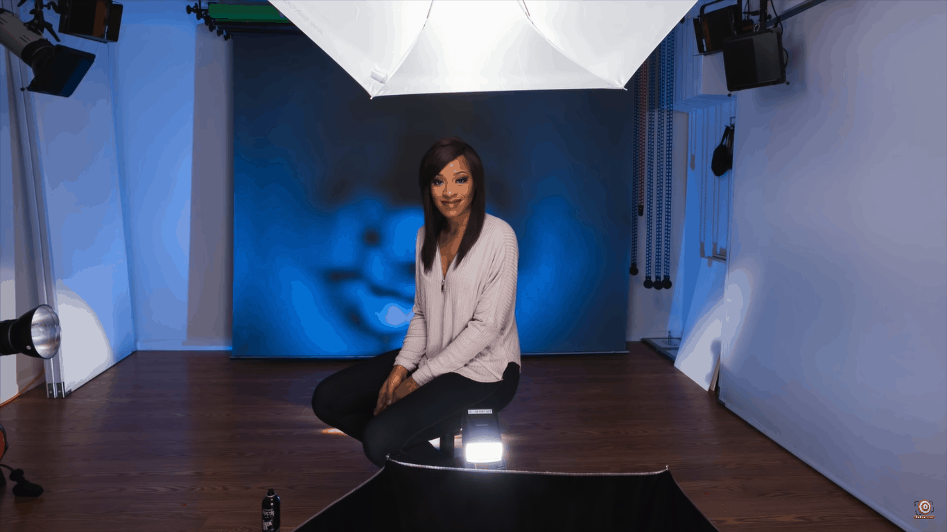 One umbrella on top as reflector, one umbrella below as gobo