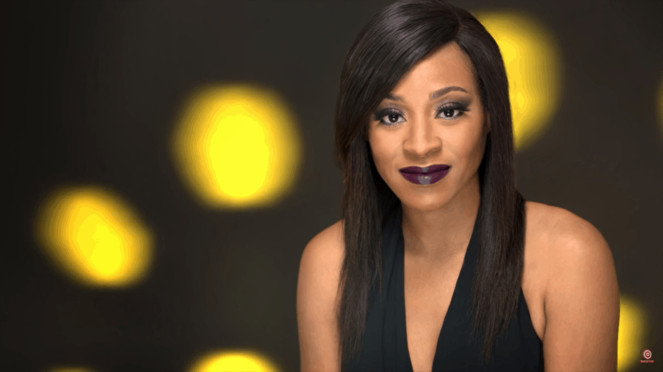 model in front of grey background with yellow circles projected