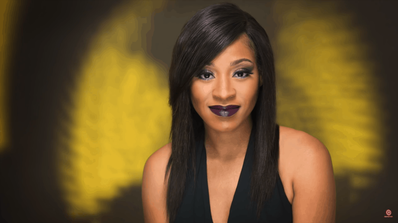 Model in front of black background with yellow table fan gobo