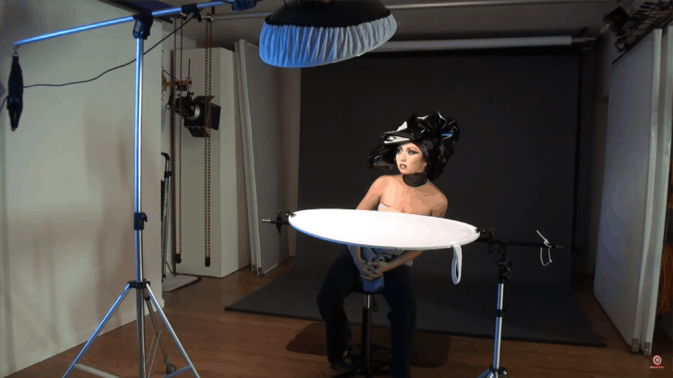 Portrait lighting setup with beauty dish below model's chin and sock above to the left