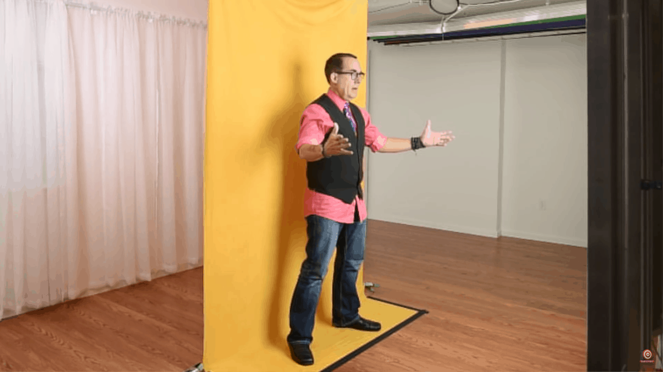 Joe standing on taped down edge of velour backdrop