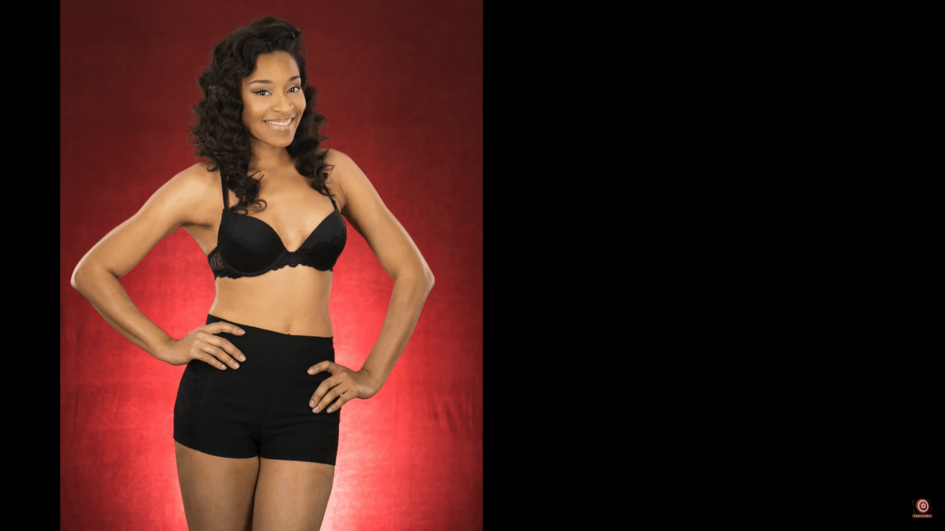 model in front of velour backdrop lit from behind three quarter legth shot