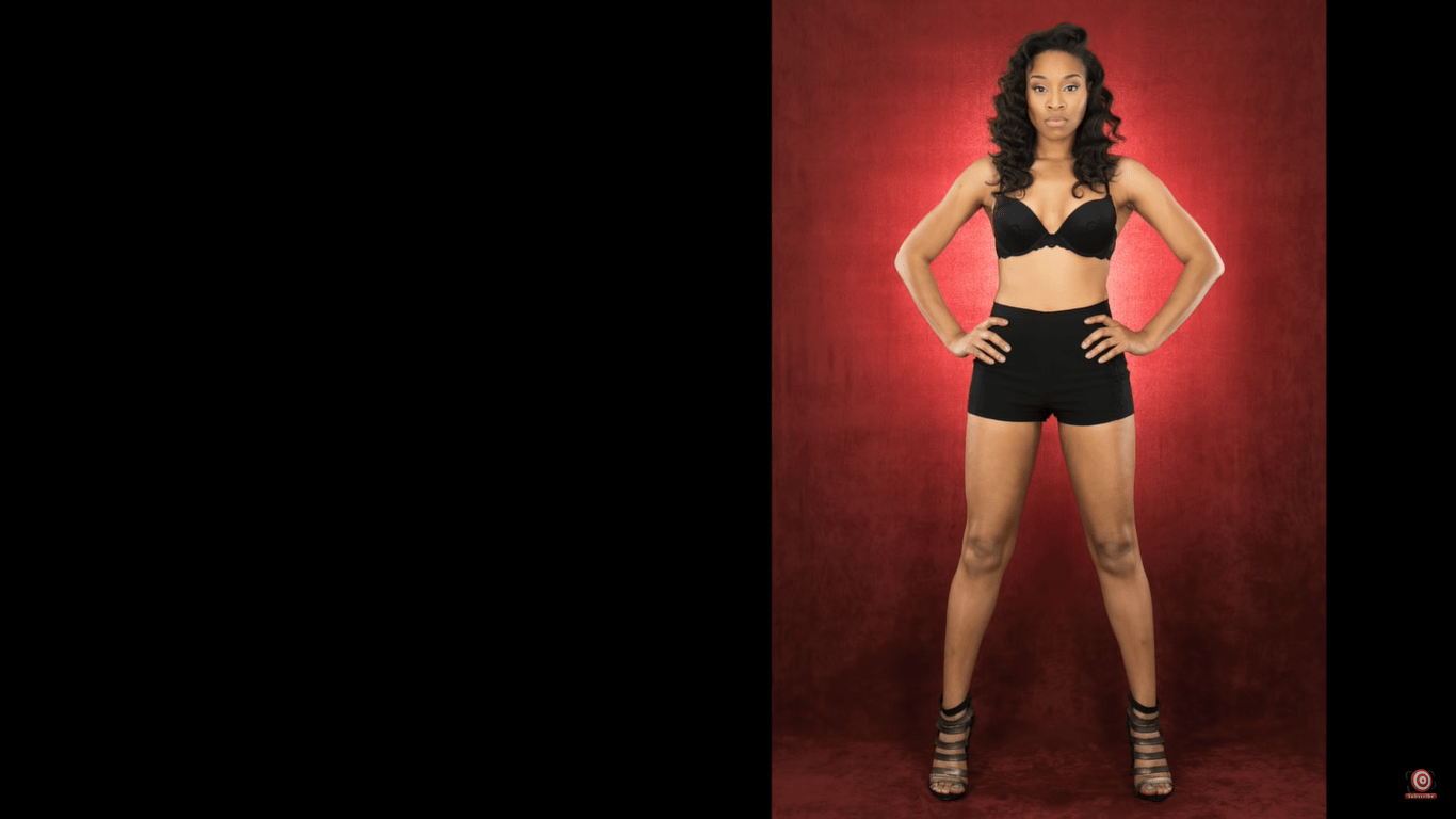 model in front of velour backdrop lit from behind full legth shot