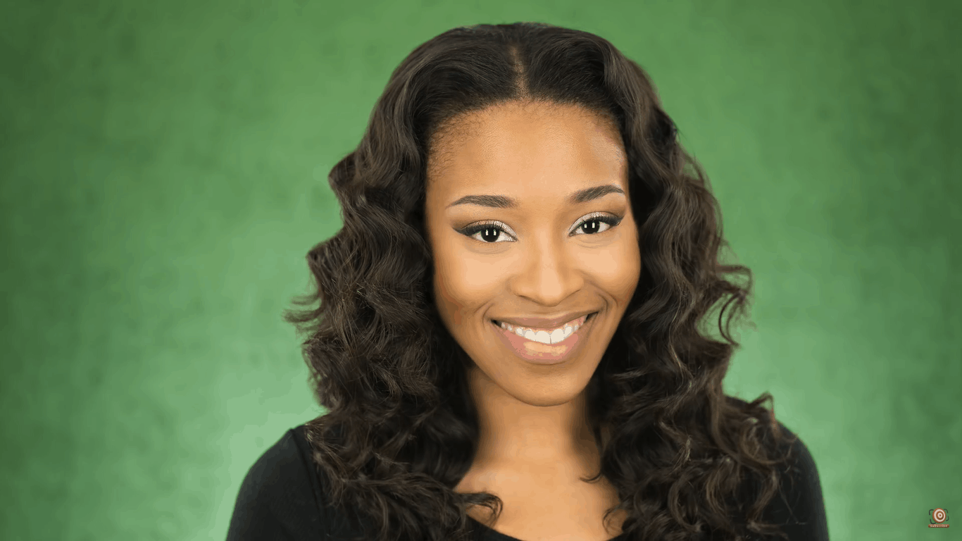 model in front of lit green velour backdrop