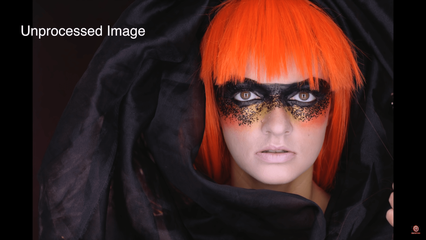 model in orange wig with black fabric wrapped around her (unprocessed image)