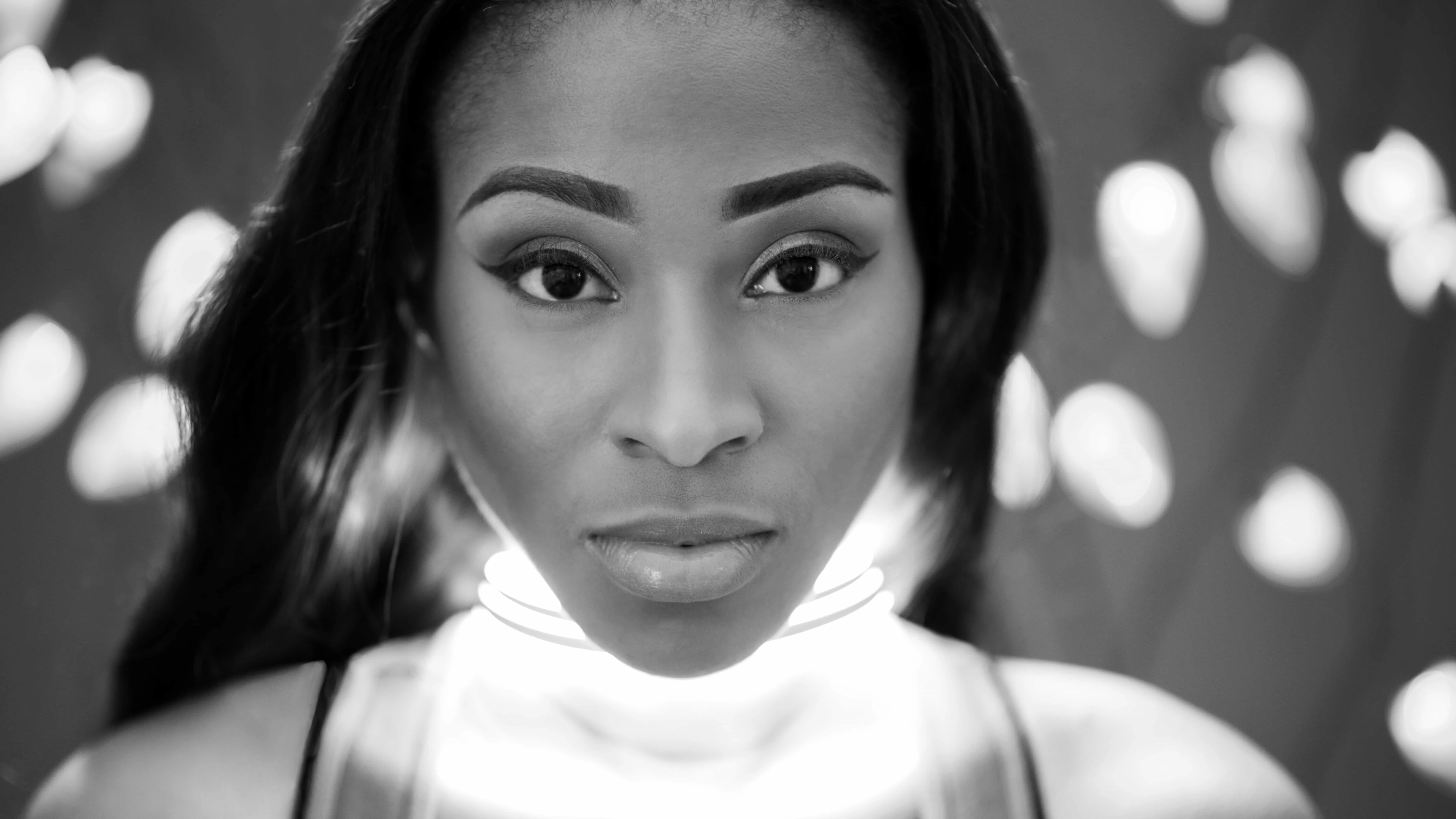 fourth of DIY Christmas light portraits with LED lights around Monae's neck in black and white
