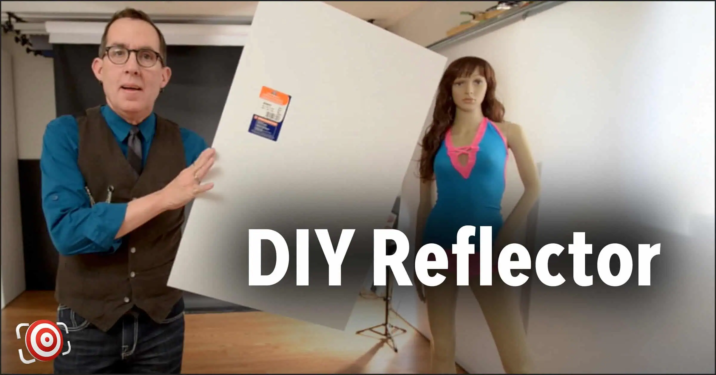 A person holds a large white foam board beside a mannequin in the photography studio. The text reads "DIY Photography Reflector," highlighting an essential tool for creating perfect lighting effects.