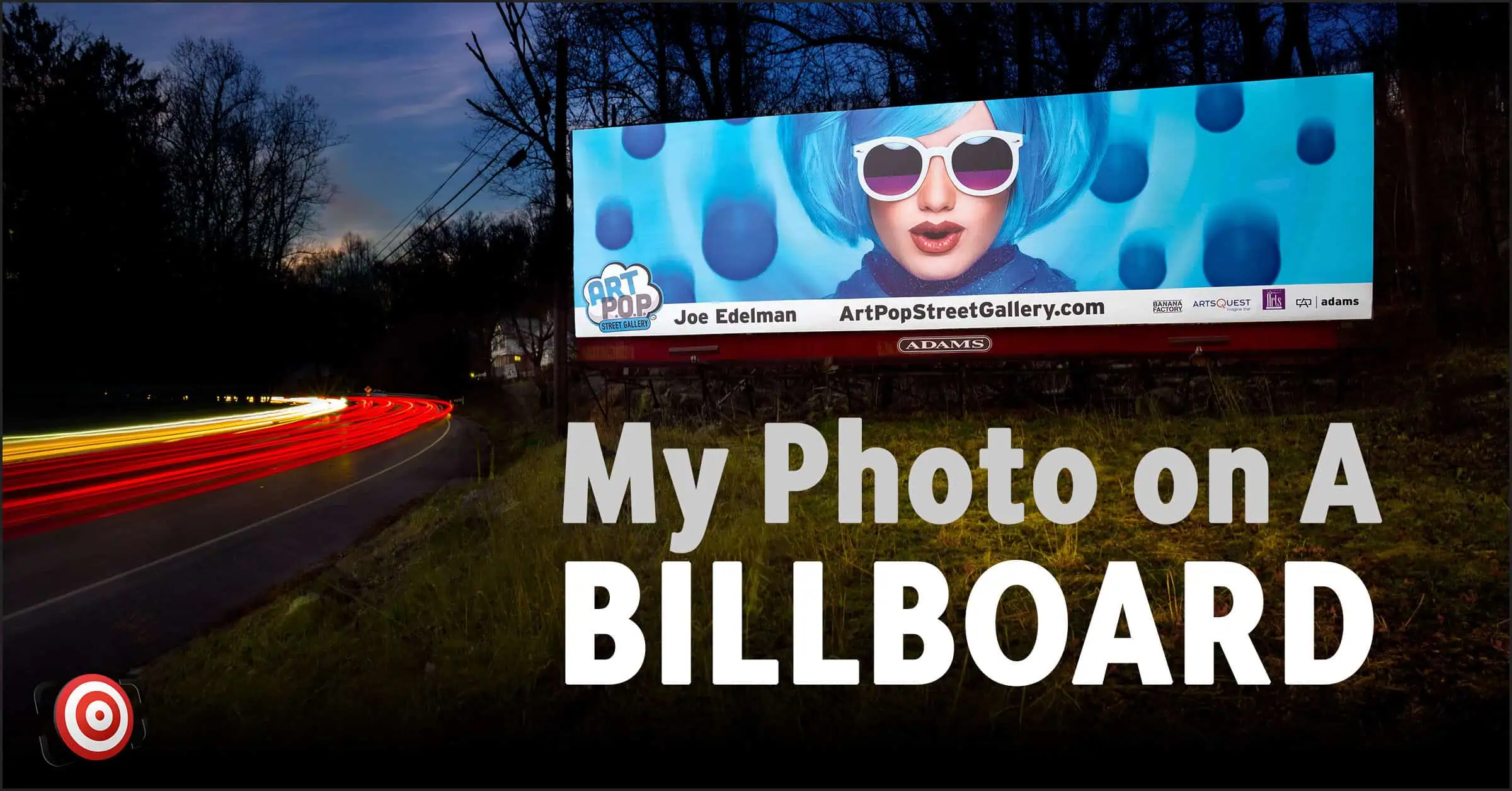 A nighttime photo captures a roadside billboard featuring a woman with blue hair and glasses, proclaiming "My Photo on A BILLBOARD." Light trails from passing cars add to the ArtPop Street Gallery vibe.