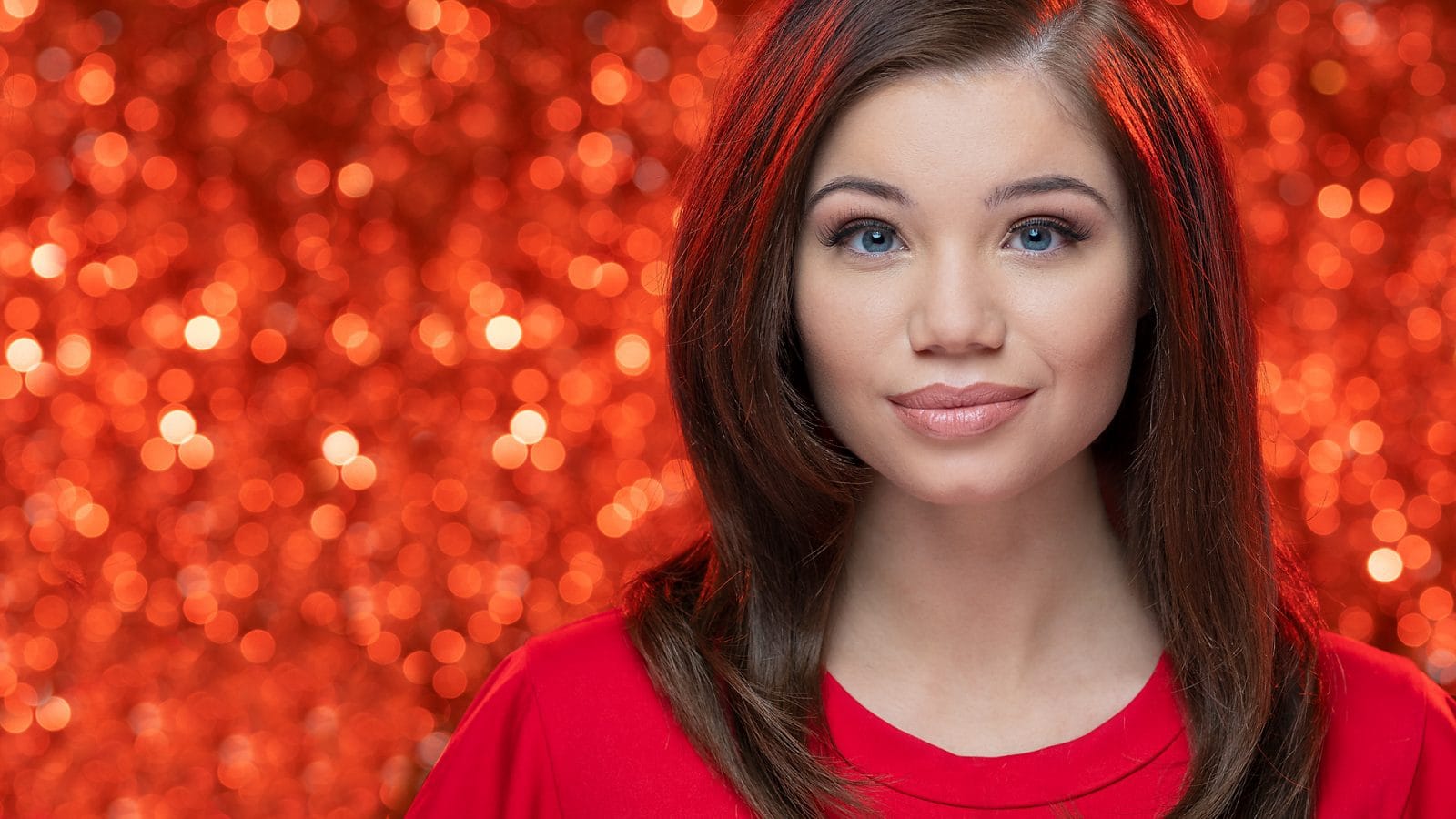 Model in front of red bokeh background