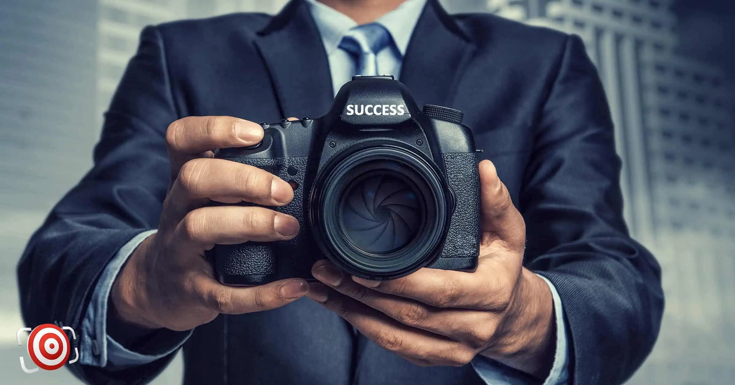 A man in a suit expertly capturing moments with a camera, showcasing the essence of what every successful photographer does.