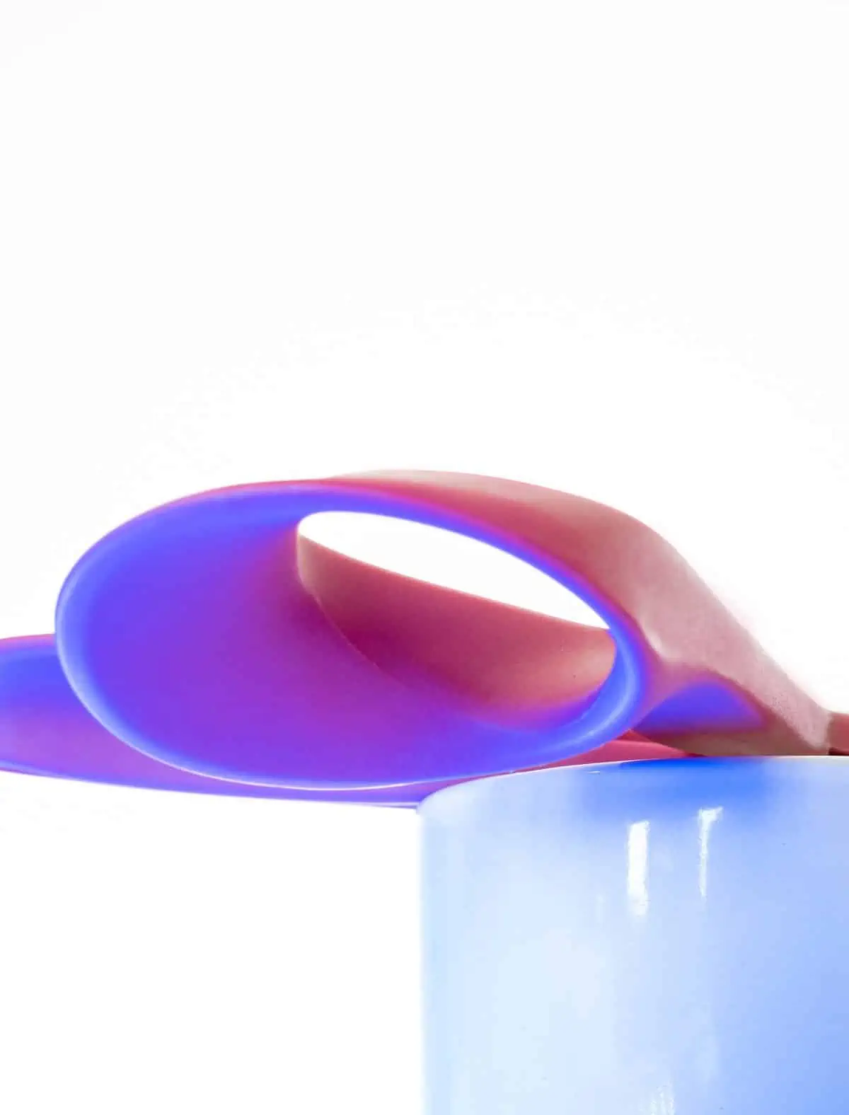 A pair of scissors in a cup.