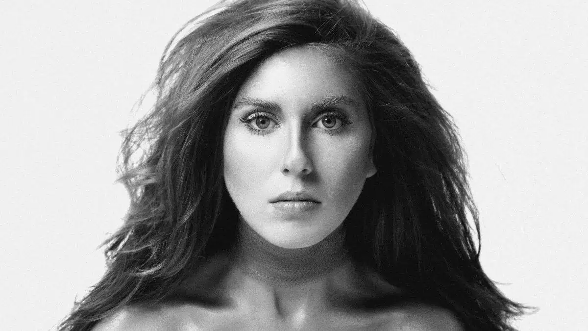 A black and white photo of a woman with long hair.