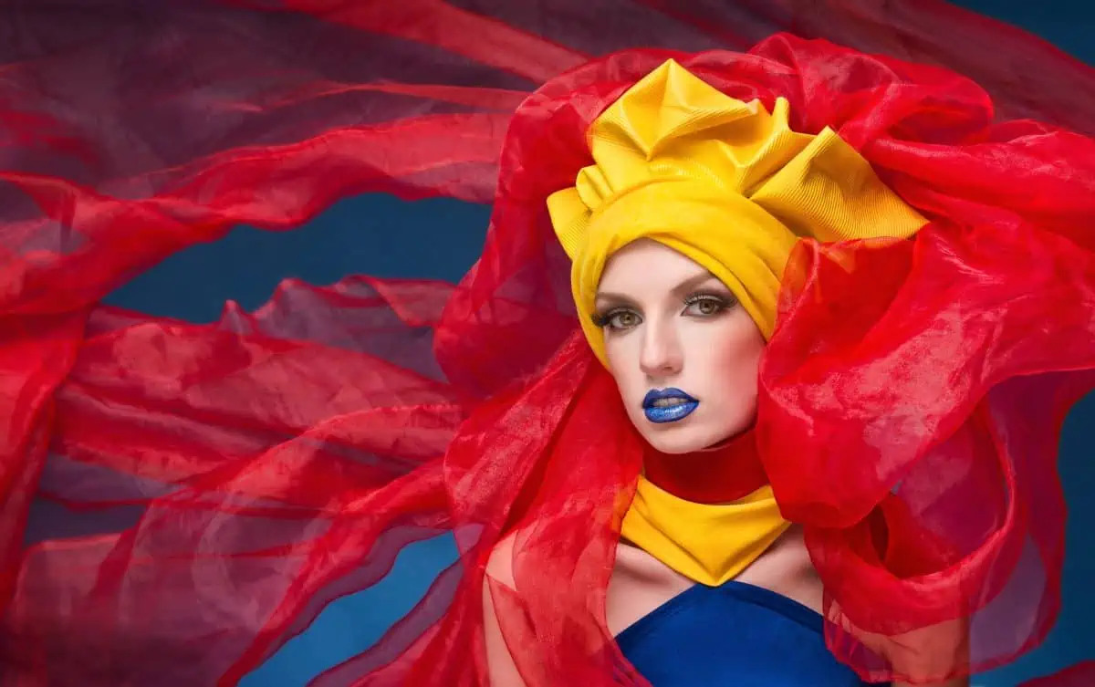 A beautiful woman in a red and yellow costume.