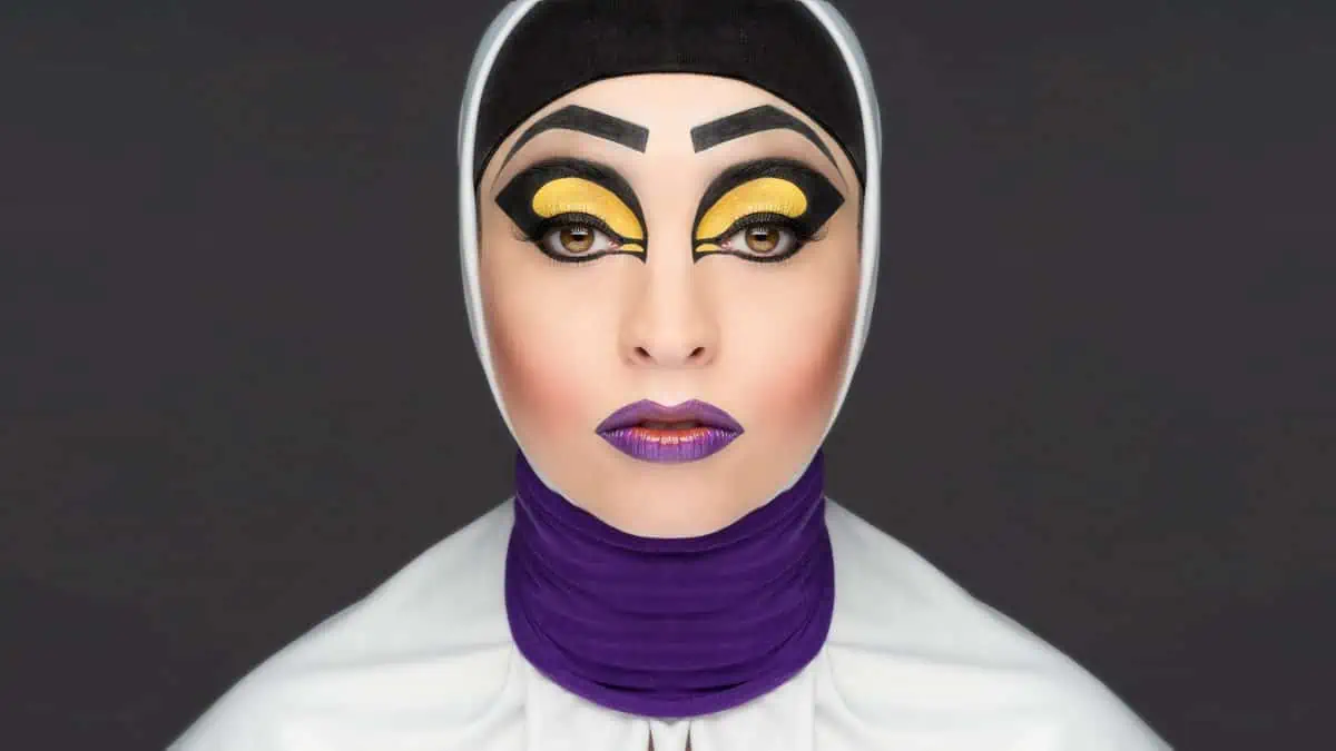 A woman with purple and yellow makeup on her face.