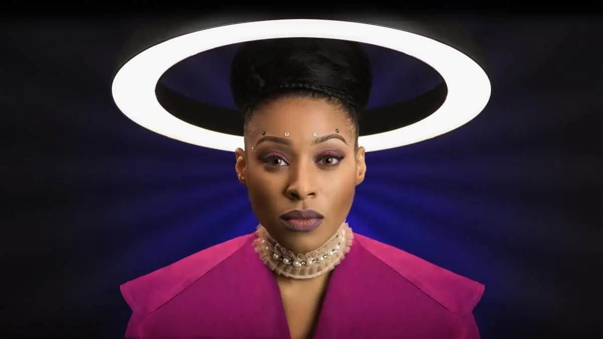 A woman in a pink jacket with a halo around her head.