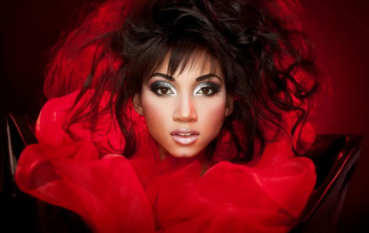A woman with long black hair in a red dress.