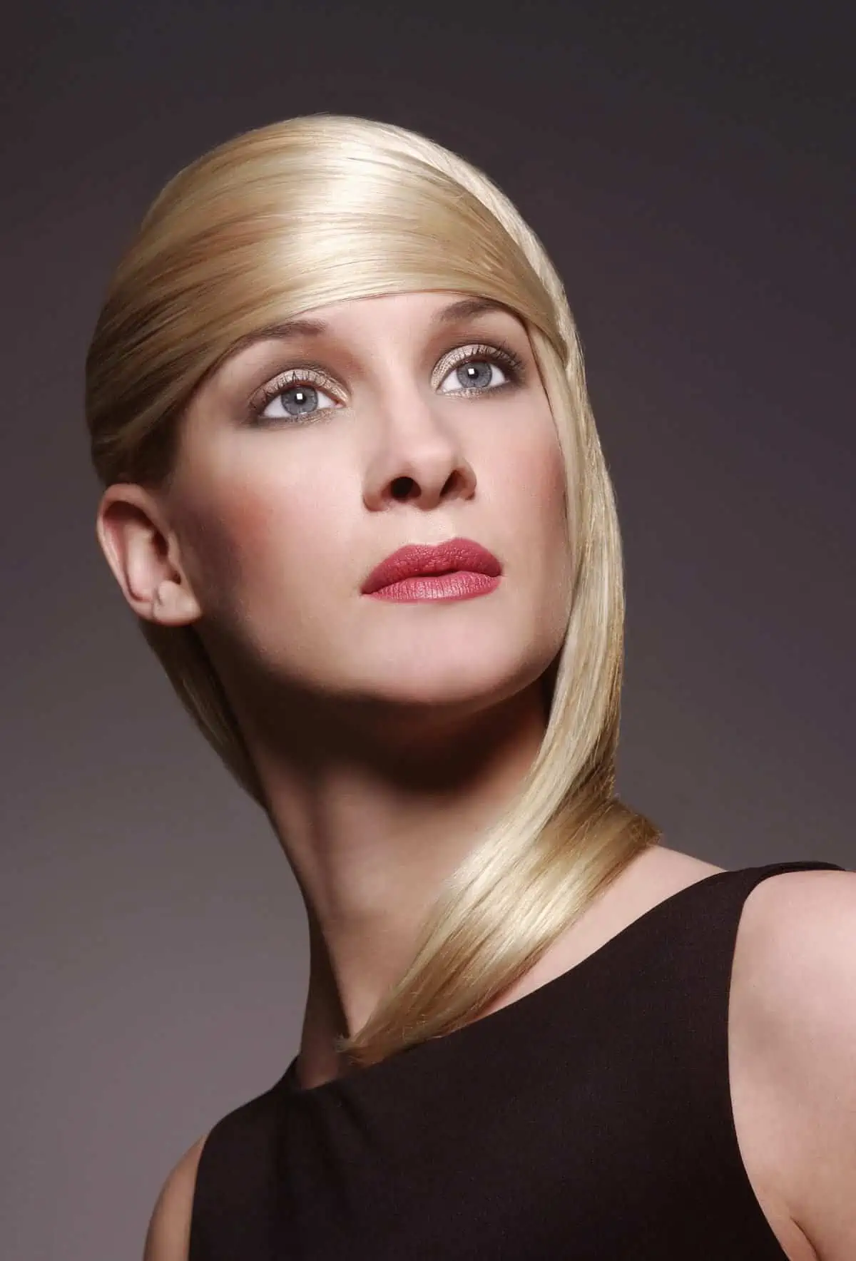 A woman with blonde hair in a black dress.