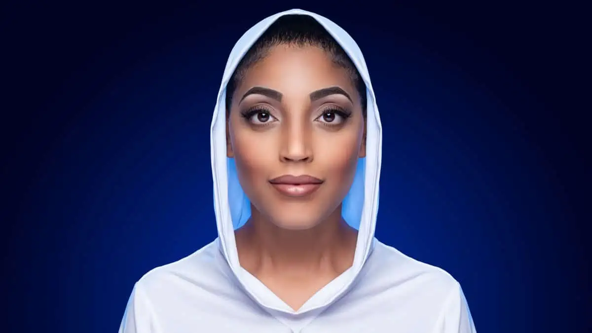 A woman in a white hoodie on a blue background.