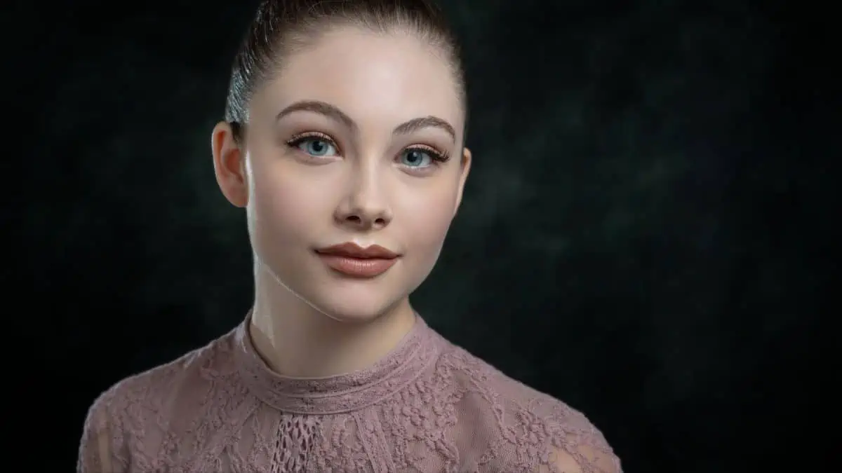 A young woman with blue eyes posing for a portrait.