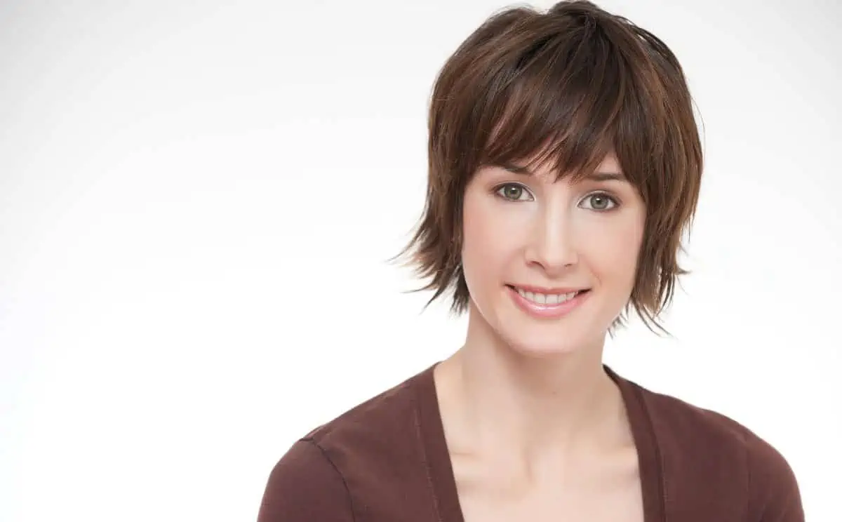 A woman with short hair smiling for the camera.