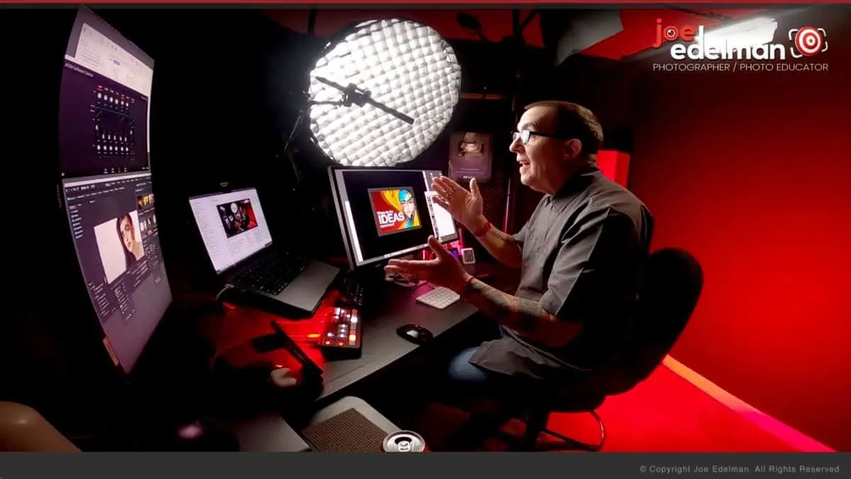 A man sitting in front of a computer screen.