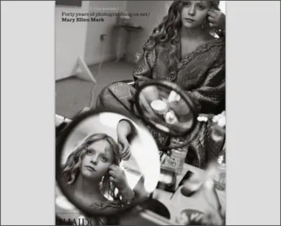 A black and white photo of a woman in a mirror.