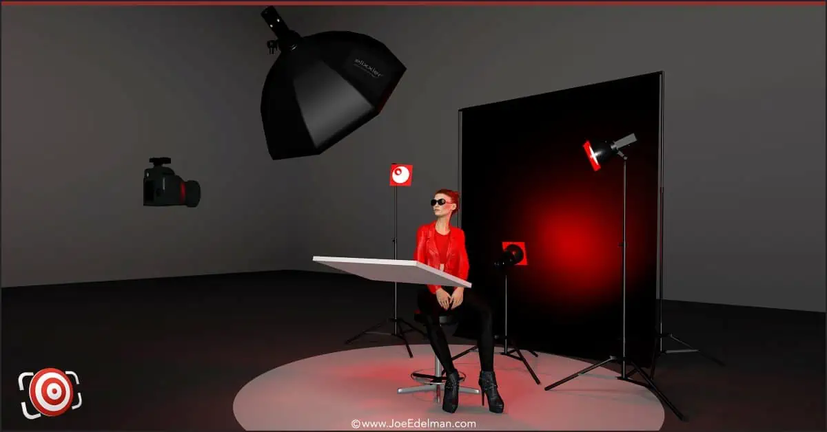 A woman is sitting in front of a red light in a studio.
