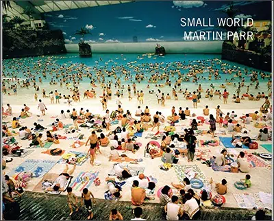 A group of people, including Eddie Adams, are laying on the beach at Small World Martin Park.