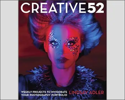 The cover of Lindsay Adler's book "Creative 52" showcases a model with dramatic makeup and spiky accessories, set against a vibrant red and purple background.