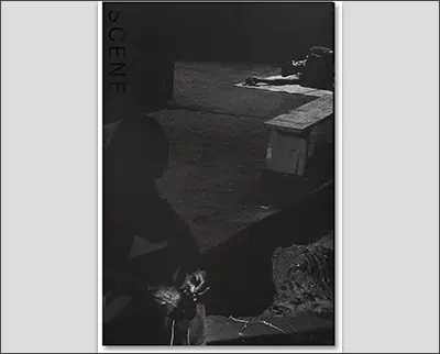 A Martin Parr black and white photo capturing a man sitting on a bench.