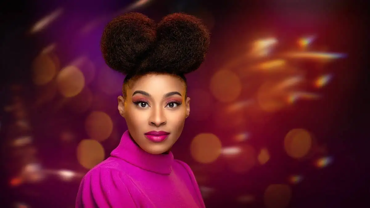 A woman with colorful makeup and a puffy hairstyle.