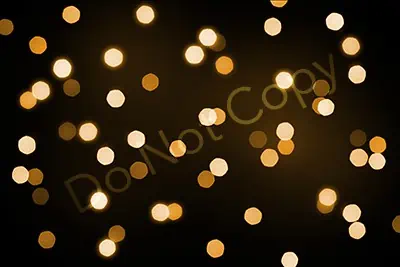 Golden lights against a dark background create a mesmerizing and captivating scene, illuminating the surroundings with an enchanting glow.