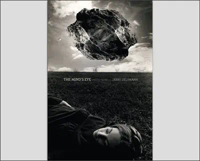 A black and white photo of a woman laying down in a field.