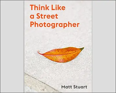 A book titled "Think like a Street Photographer" by Lindsay Adler with an autumn leaf on the cover.