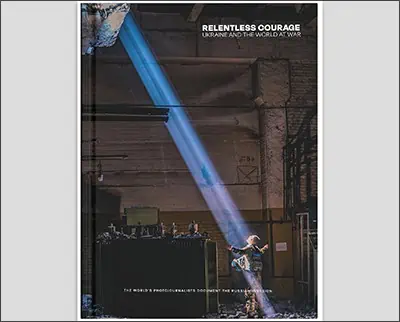 A promotional poster for a documentary titled "Relentless Courage: Ukraine and the World at War," featuring a silhouette of a person spotlighted by a beam of light in an industrial setting, captured by
