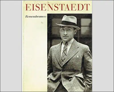 A cover of the book "eisenstaedt: remembrances" featuring a black and white photo by Dorothea Lange of a man in a suit and hat looking slightly surprised or