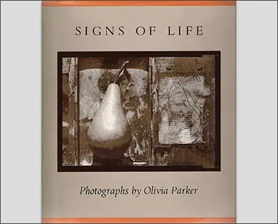 Cover of the book 'Signs of Life' featuring a photograph of a pear and abstract drawings, with the text 'photographs by Kyle Cassidy'.