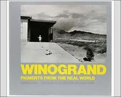 Book cover for "winogrand: figments from the real world," featuring a black and white photograph of a child running outside a building with mountains in the background.