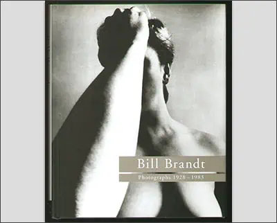 Cover of the book titled "Bill Brandt: Photographs 1928-1983," featuring a black and white photograph of a person with their arm covering part of their face.