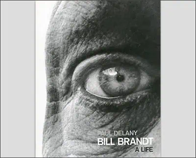 Close-up of a book cover showing an extreme close-up of an eye. The text on the cover reads "Paul Delany, Bill Brandt, A Life.