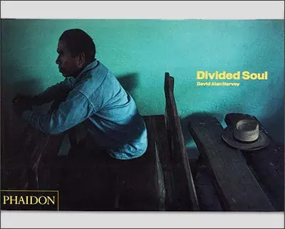 The cover of "Divided Soul" by David Alan Harvey, featuring a photograph reminiscent of Joe McNally's style, shows a person sitting on a bench against a teal background with a hat resting on the bench nearby.