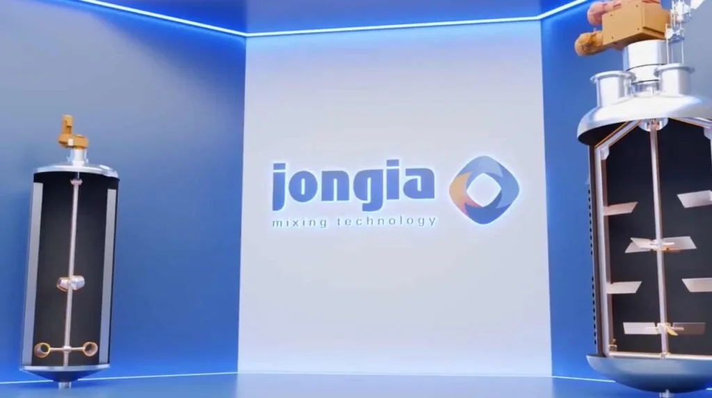 Two industrial mixing tanks with internal paddles stand in a modern room with blue lighting. The wall behind them features the Jongia logo and the text mixing technology, highlighting advanced solutions for efficient mixing processes.