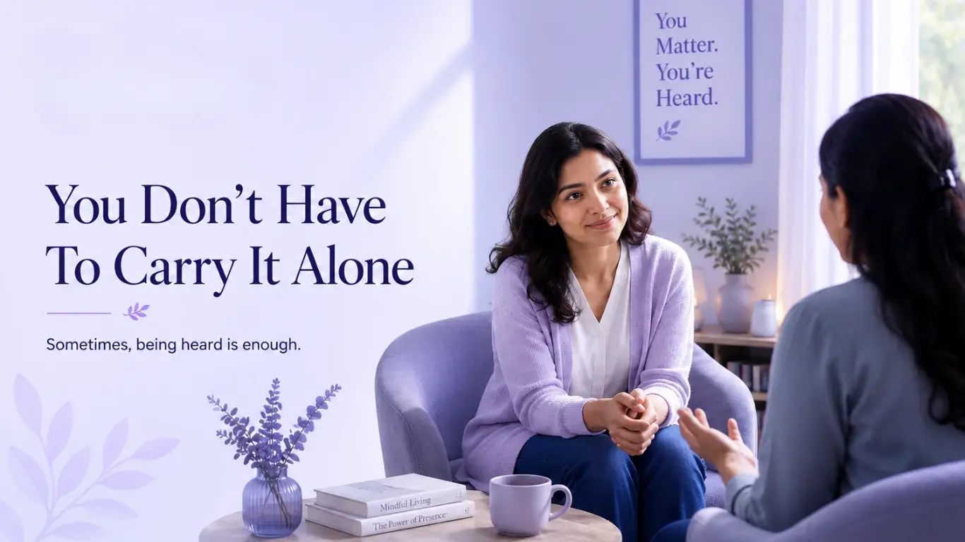A compassionate listener sitting with a woman in a calm, lavender-colored setting, illustrating emotional support and human connection for people experiencing loneliness.