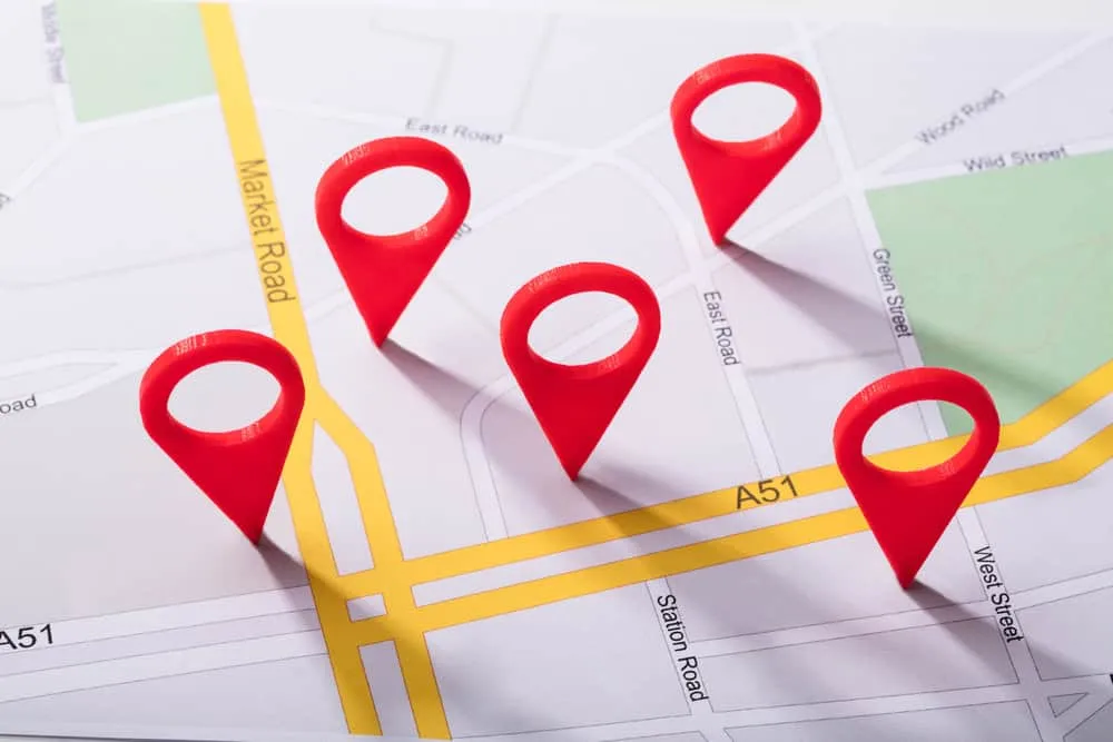 A map with yellow roads and several red location pins placed on different intersections and streets, representing local business citations or points of interest marked for improved local SEO.