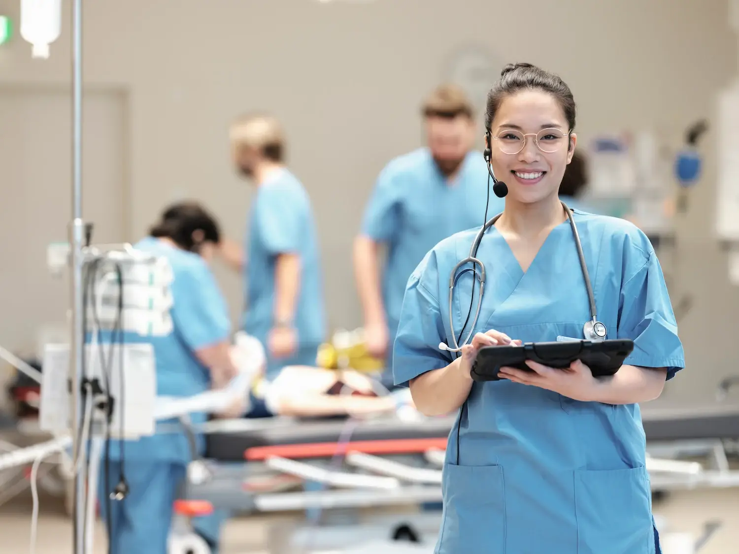SIMStation healthcare simulation training – medical team in hospital emergency room using AV technology for patient care and professional collaboration.