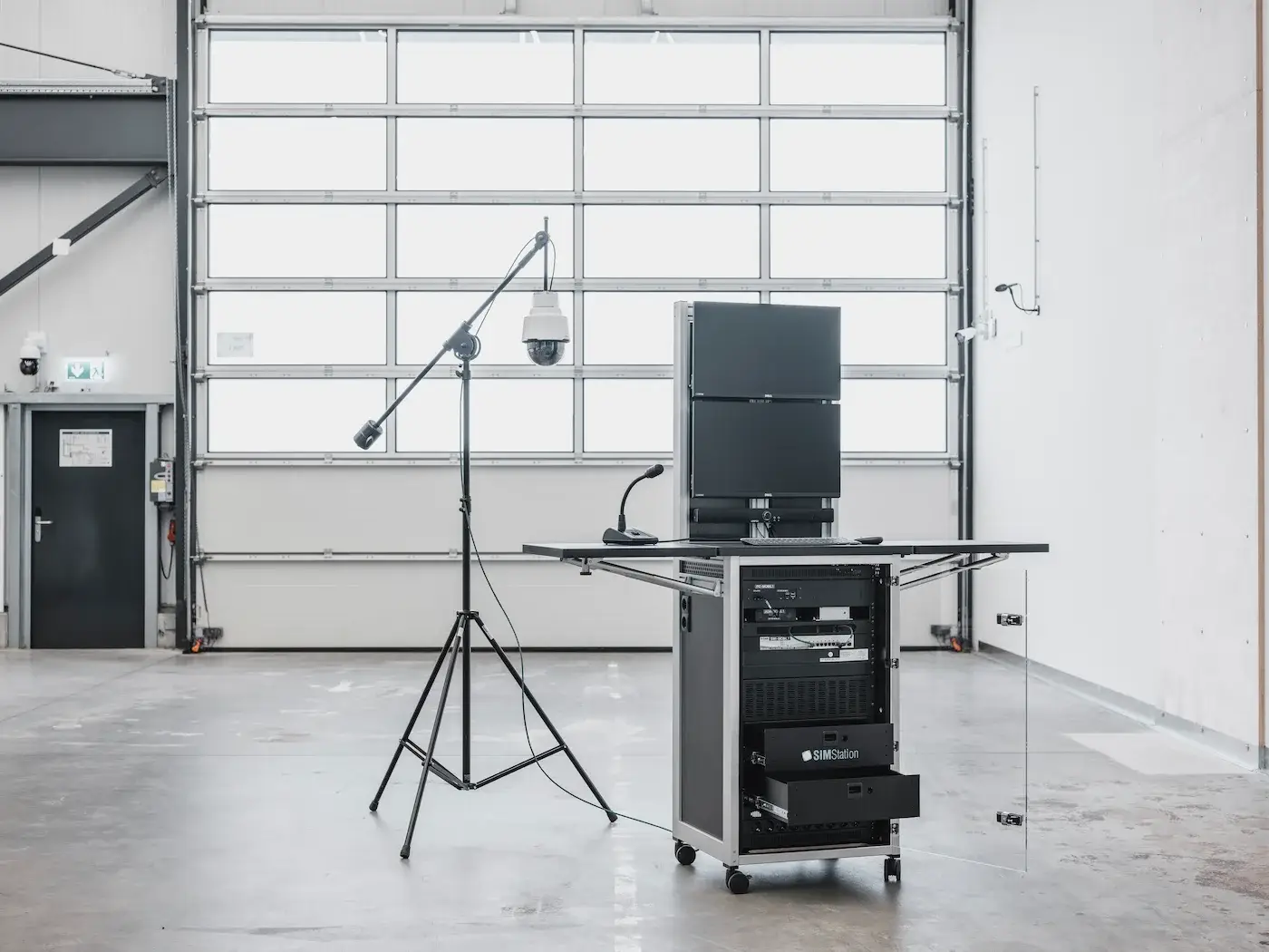 A portable, all-in-one mobile simulation unit featuring integrated monitors, rack-mounted hardware, and an adjustable camera stand for in-situ training.